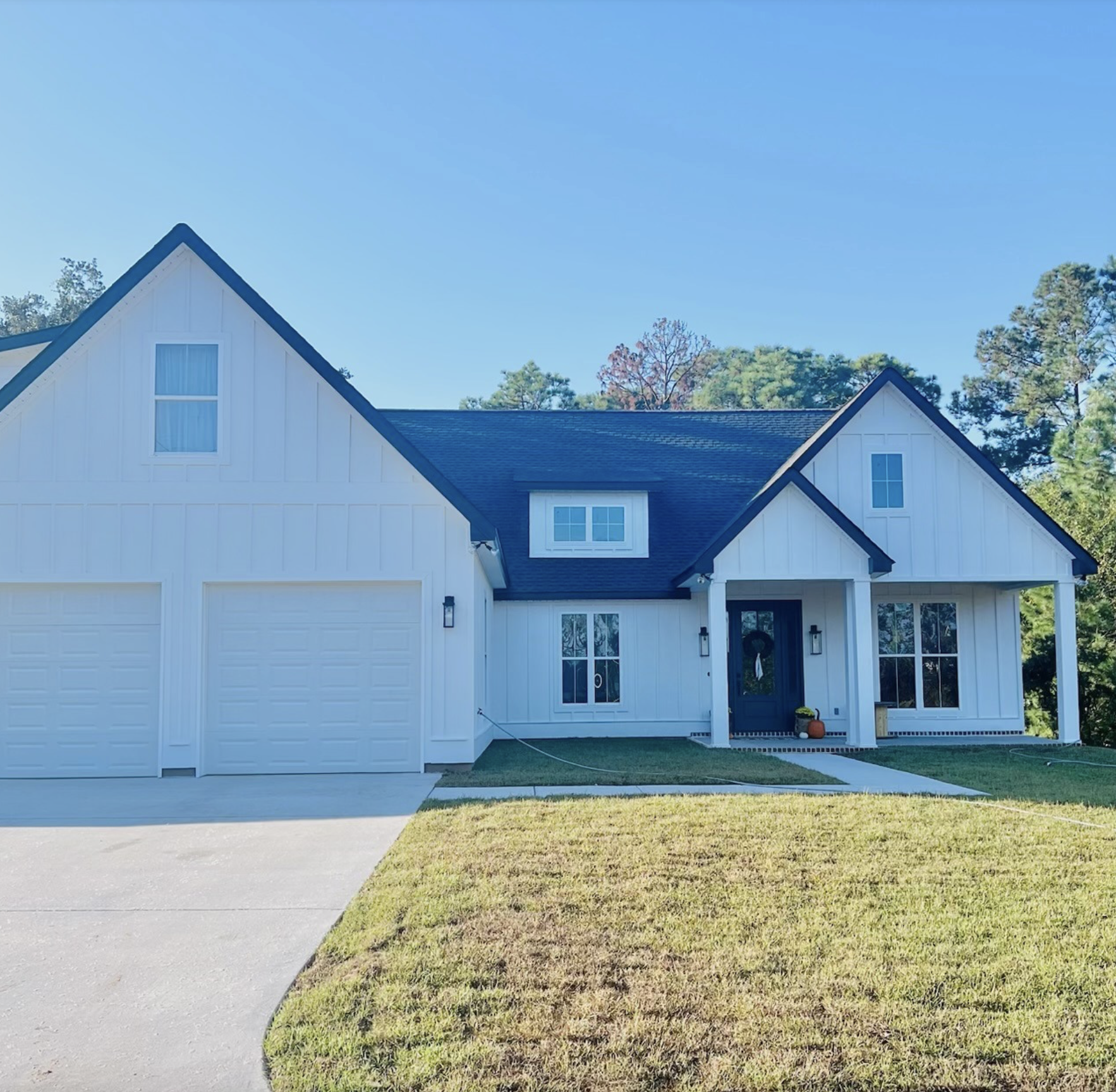 White modern farmhouse custom home exterior by a home builder in Bay St. Louis MS
