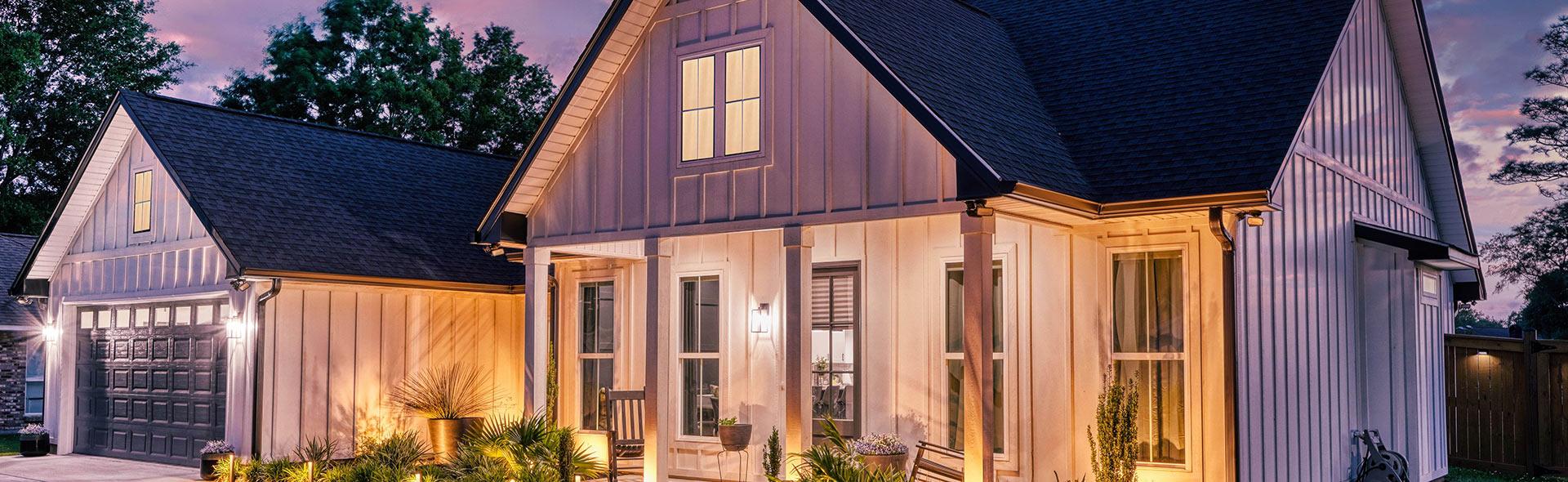 Modern farmhouse custom home exterior at dusk in Diamondhead MS