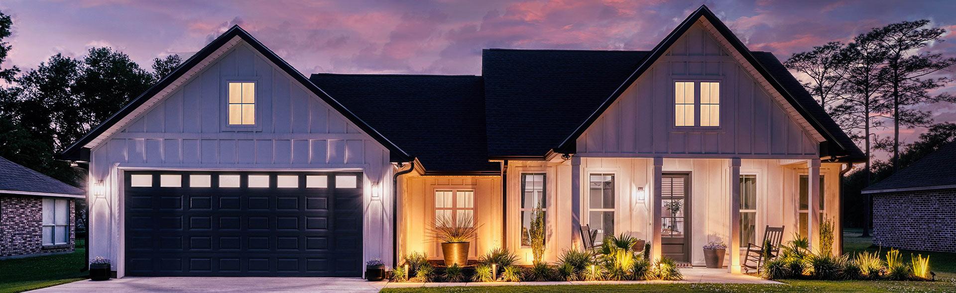 Modern farmhouse custom home at dusk by a custom home builder in Gulfport MS