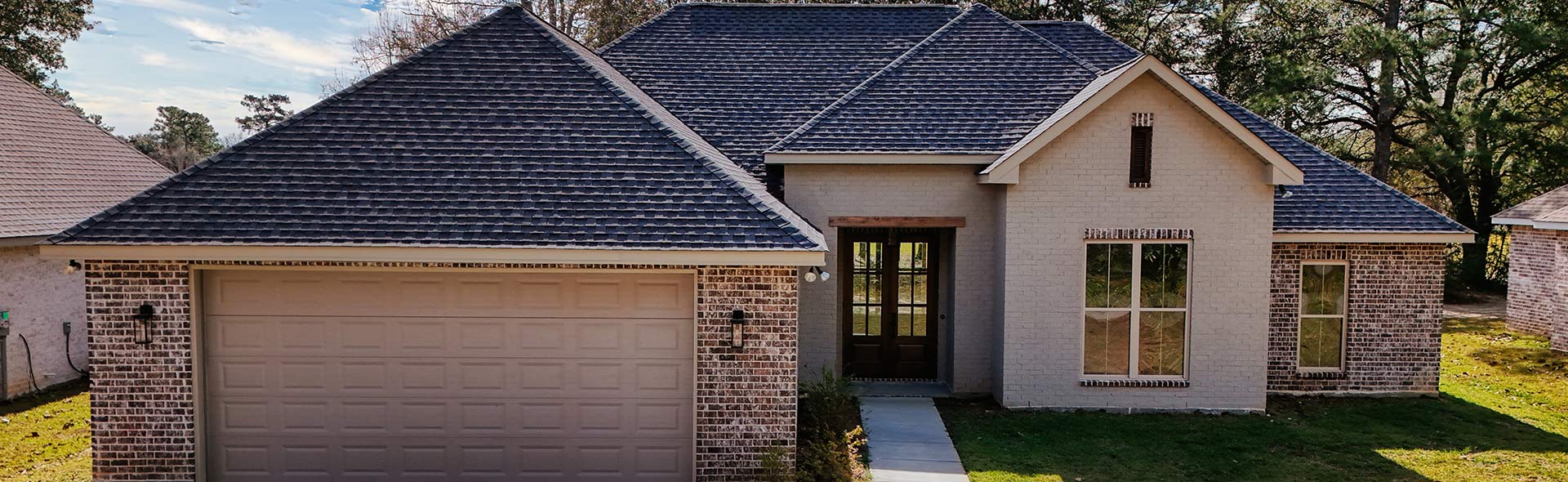 Brick custom home exterior with garage by a custom home builder in Bay St. Louis MS