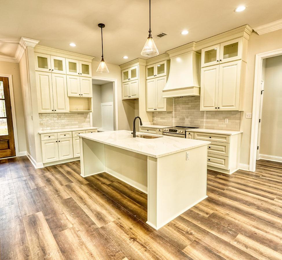 Kitchen with island and cabinets by a custom home builder in Diamondhead MS