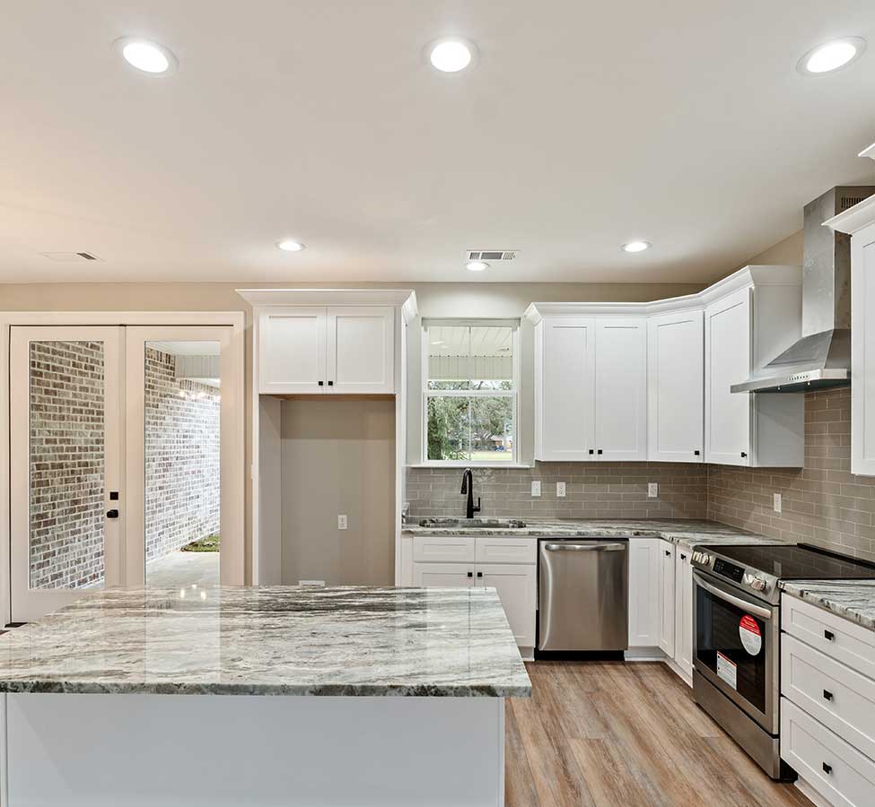 Remodeled kitchen with white cabinets and home additions in Bay St. Louis MS