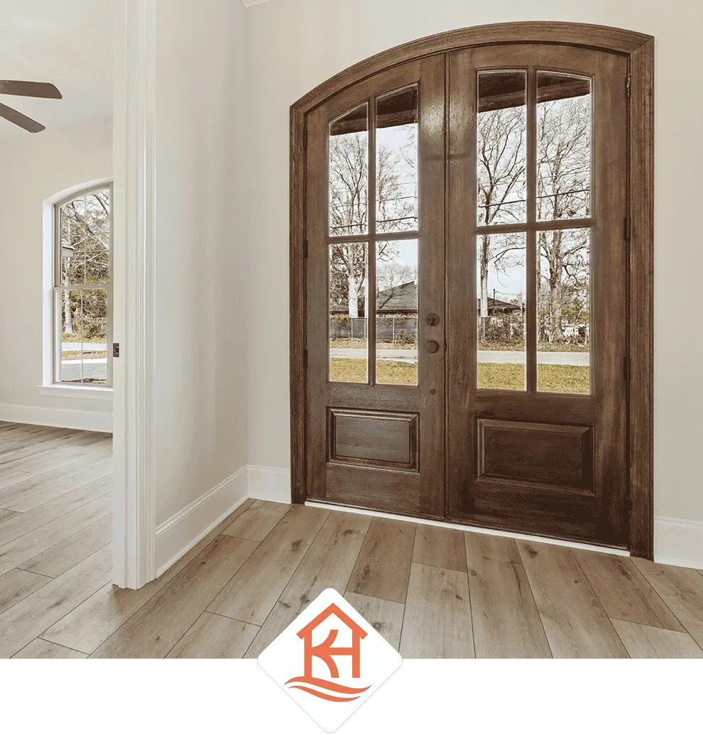 Entry with wood and glass double doors in a custom home in Waveland MS